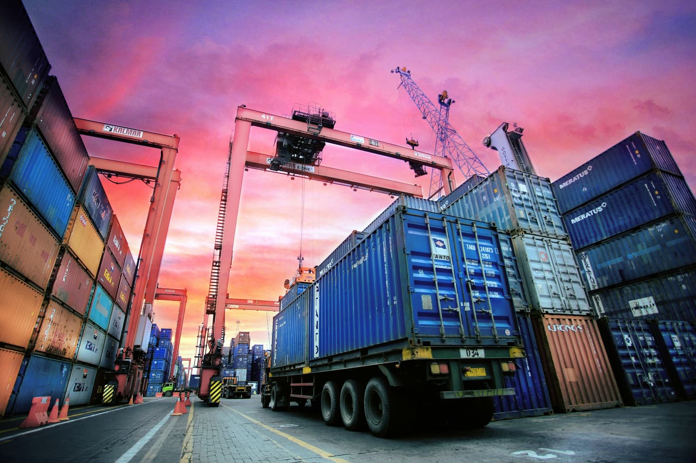 Container port at dusk, cranes loading cargo containers